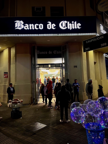 White sign for "Banco de Chile" using Gothic typeface.